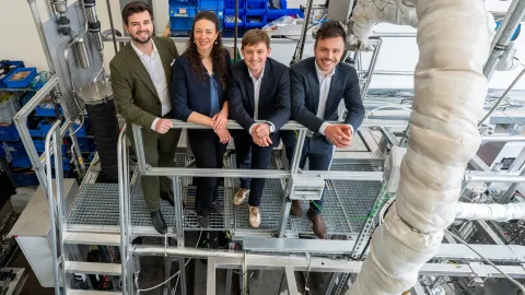 Die vier Gründenden von Cyclize stehen auf der Pilotanlage, die im Technikum der Universität Stuttgart steht.